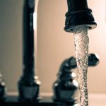 close up water running from tap