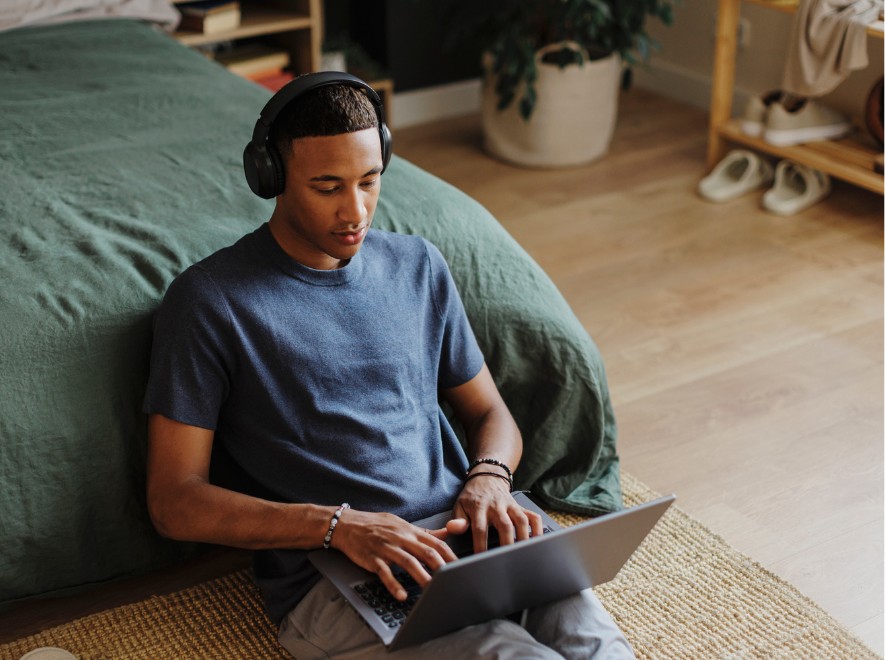 A young male studying and looking at his laptop