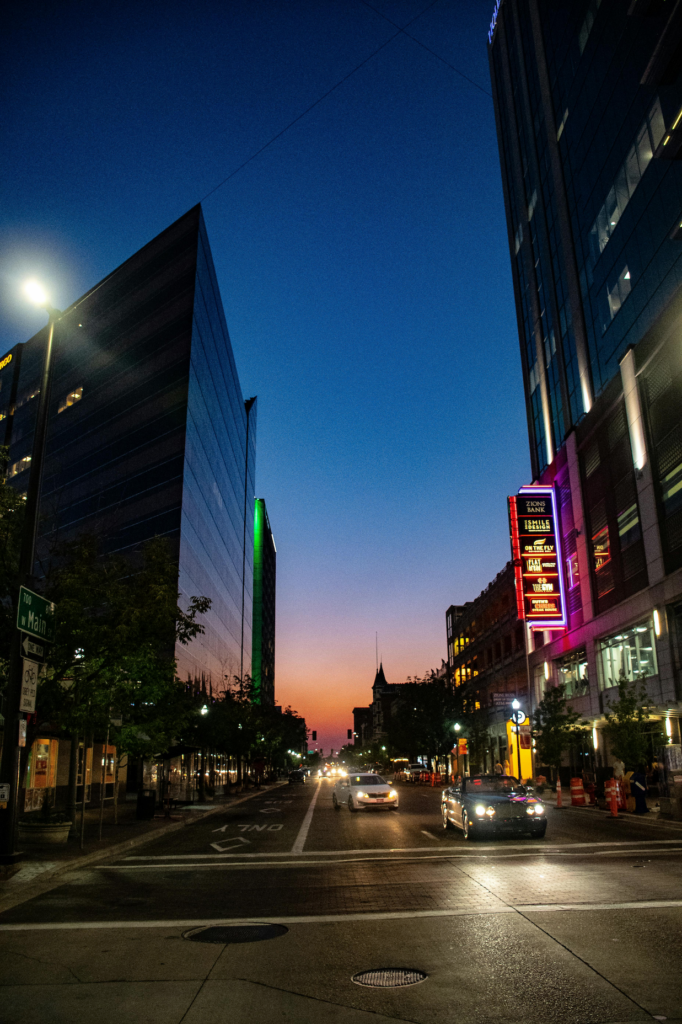 Downtown street at dusk with neon lights