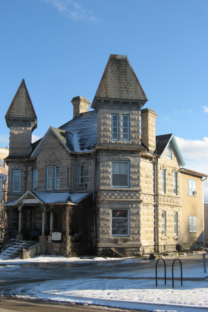 Historic stone building with twin towers in winter